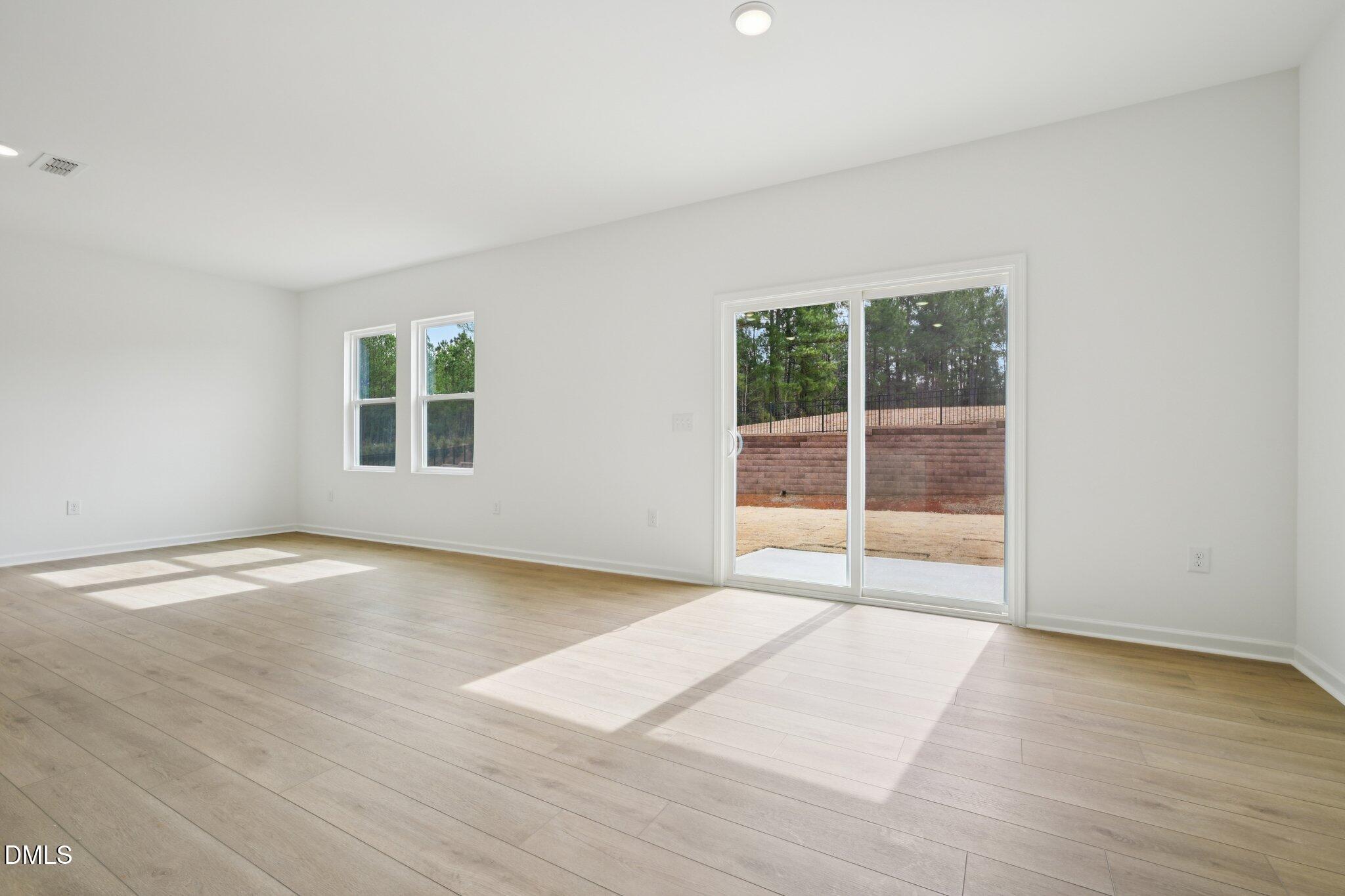 11793 Salers Loop Middlesex, NC 27557 - Photo 16 of 53 an empty room with wooden floor and windows