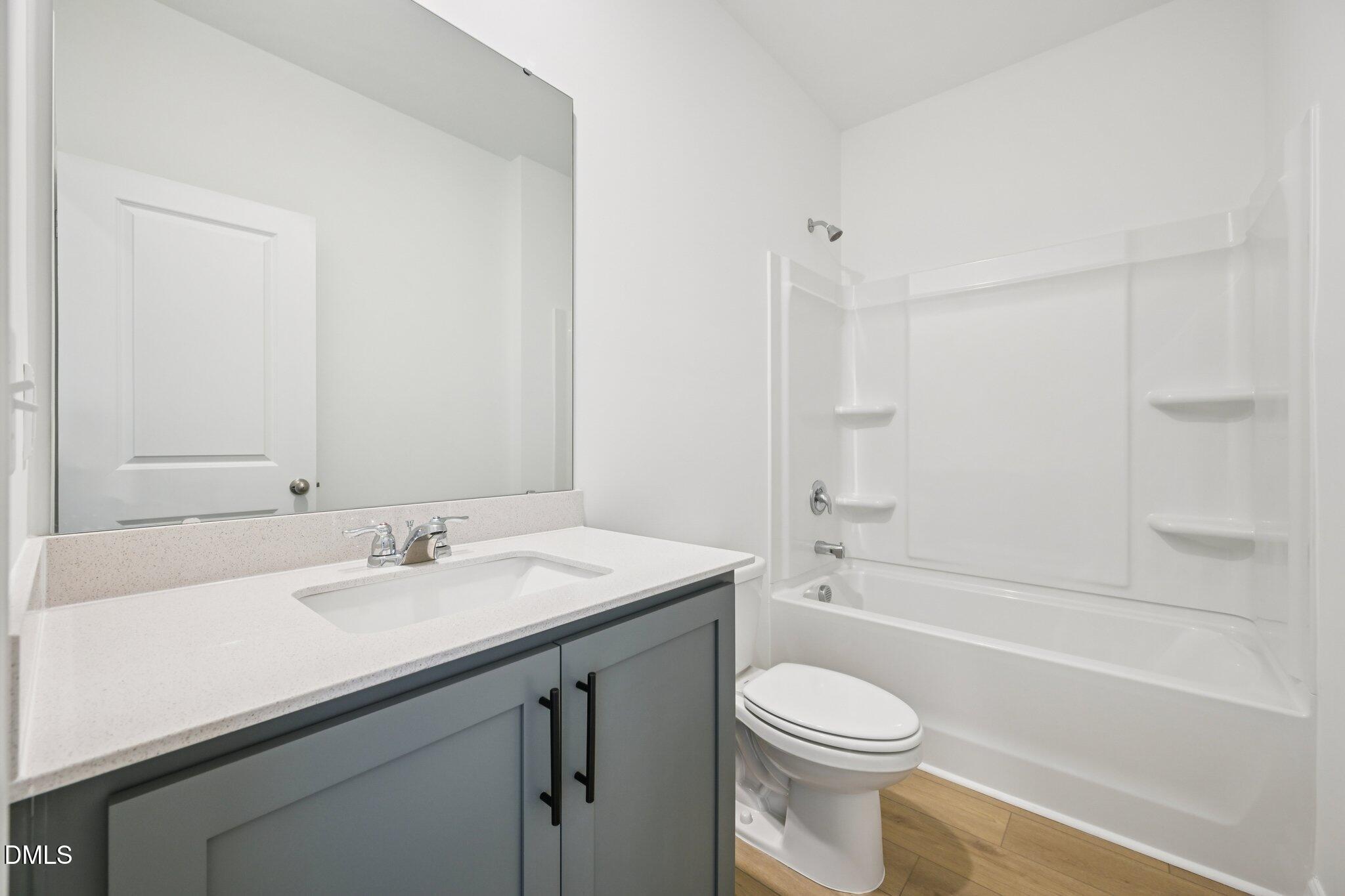 11793 Salers Loop Middlesex, NC 27557 - Photo 19 of 53 a bathroom with a sink a toilet and shower