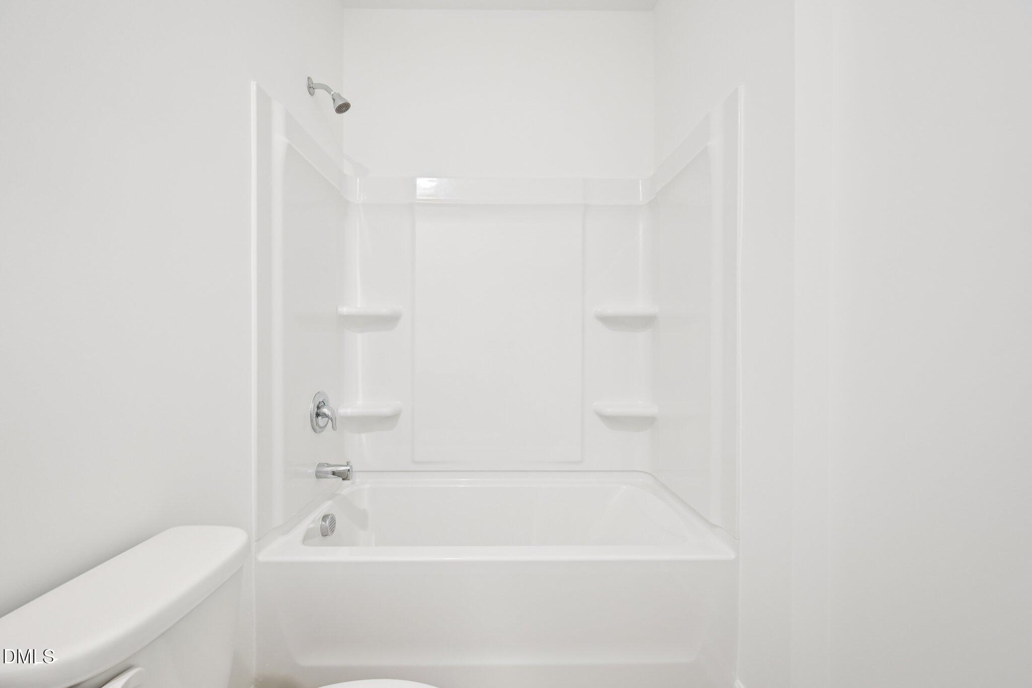 11793 Salers Loop Middlesex, NC 27557 - Photo 20 of 53 a bathroom with a bathtub and a toilet