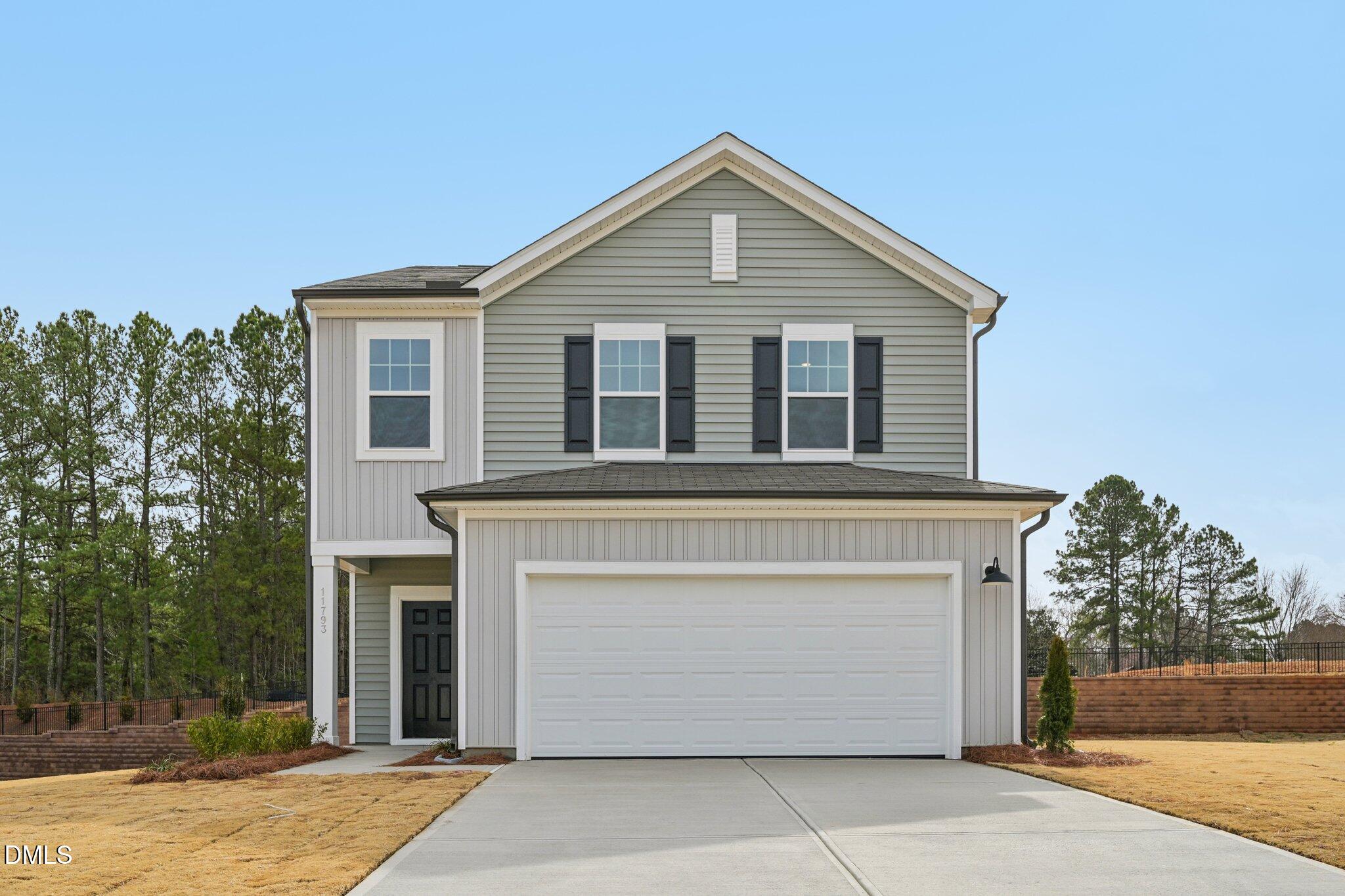 11793 Salers Loop Middlesex, NC 27557 - Photo 2 of 53 a front view of a house with a garden