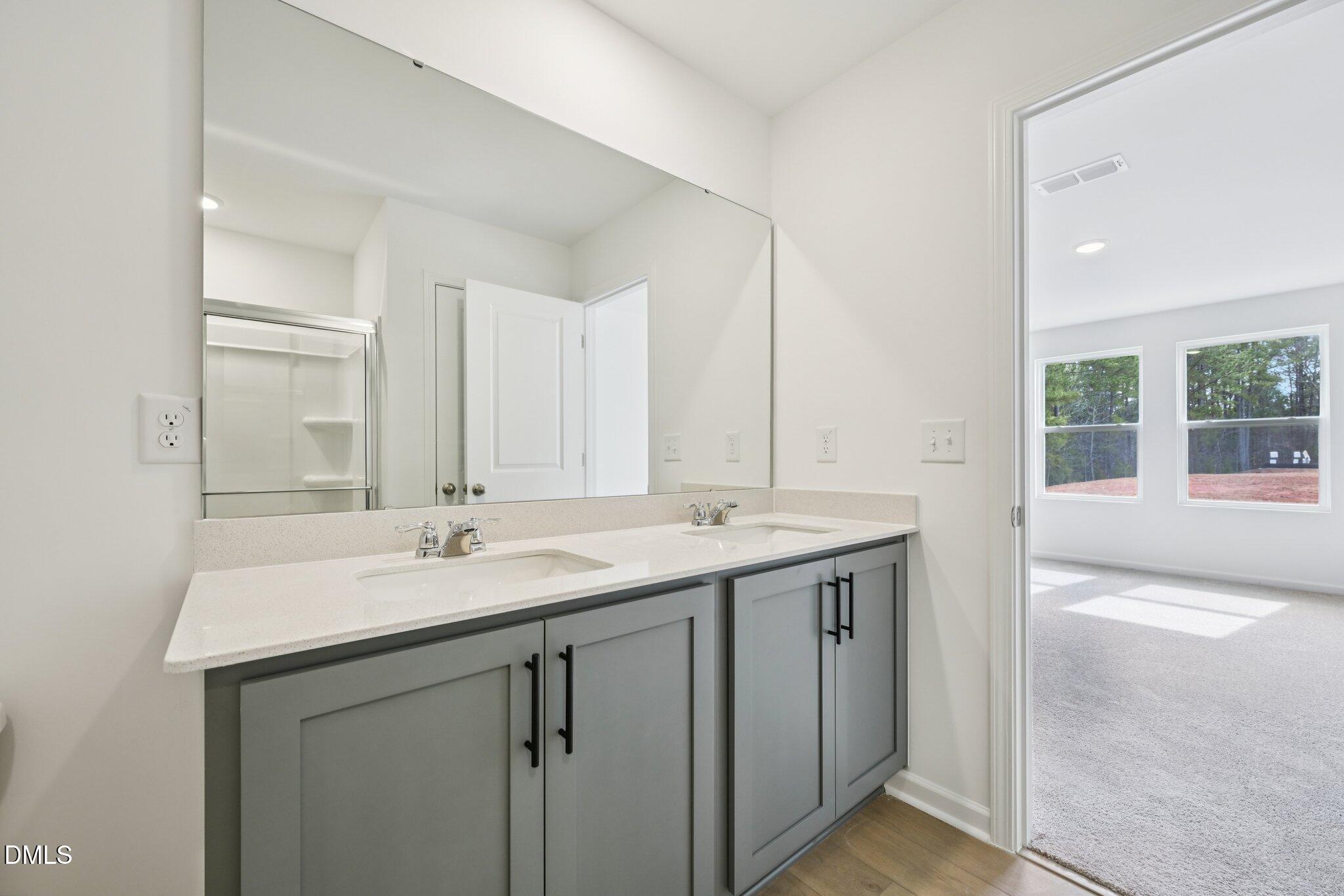 11793 Salers Loop Middlesex, NC 27557 - Photo 28 of 53 a bathroom with a sink double vanity and a mirror