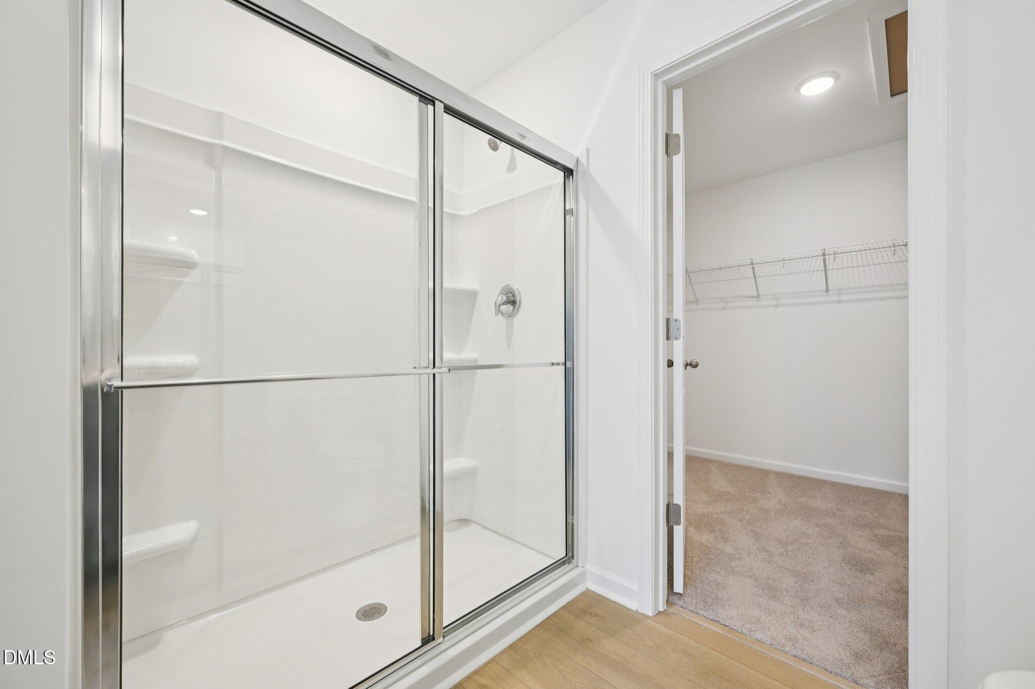 11793 Salers Loop Middlesex, NC 27557 - Photo 29 of 53 a bathroom with a glass shower door