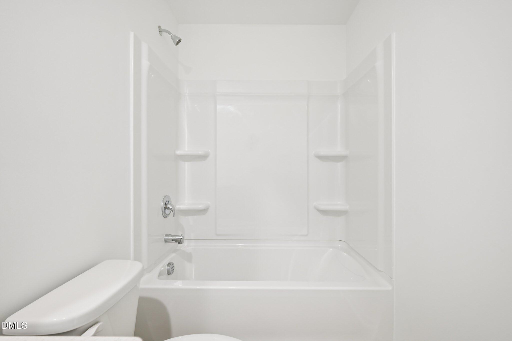 11793 Salers Loop Middlesex, NC 27557 - Photo 34 of 53 a bathroom with a bathtub and a toilet
