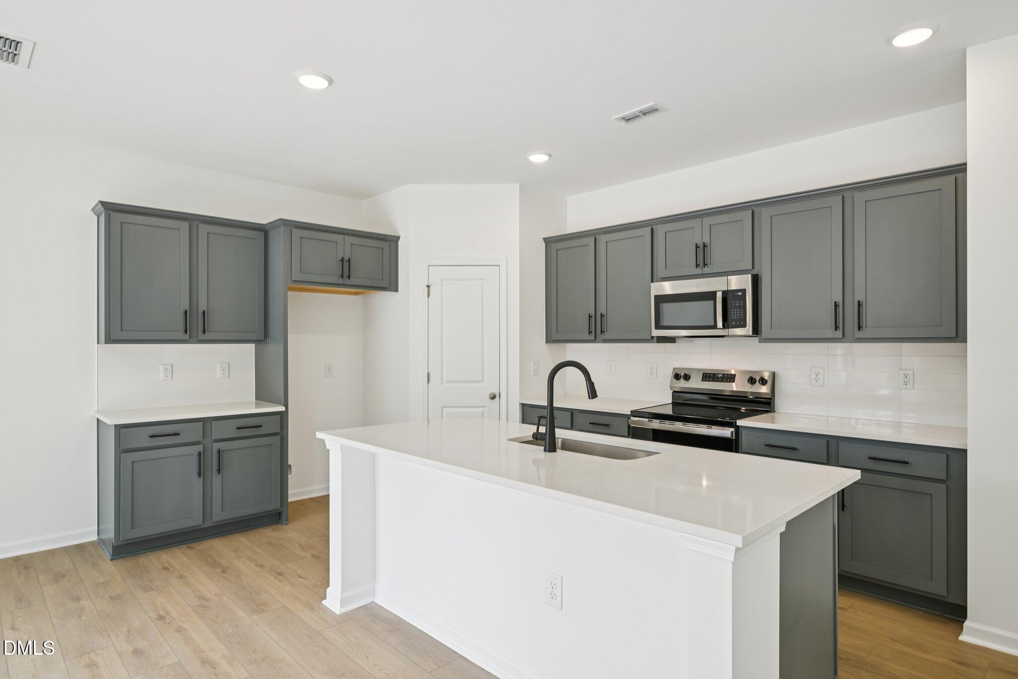 11793 Salers Loop Middlesex, NC 27557 - Photo 4 of 53 a kitchen that has a sink and a stove in it