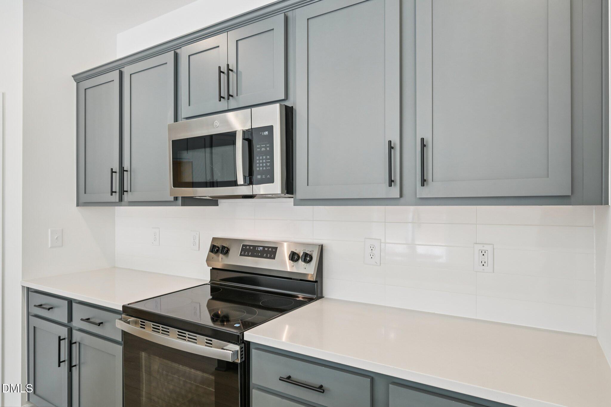 11793 Salers Loop Middlesex, NC 27557 - Photo 10 of 53 a kitchen with microwave cabinets and a stove top oven