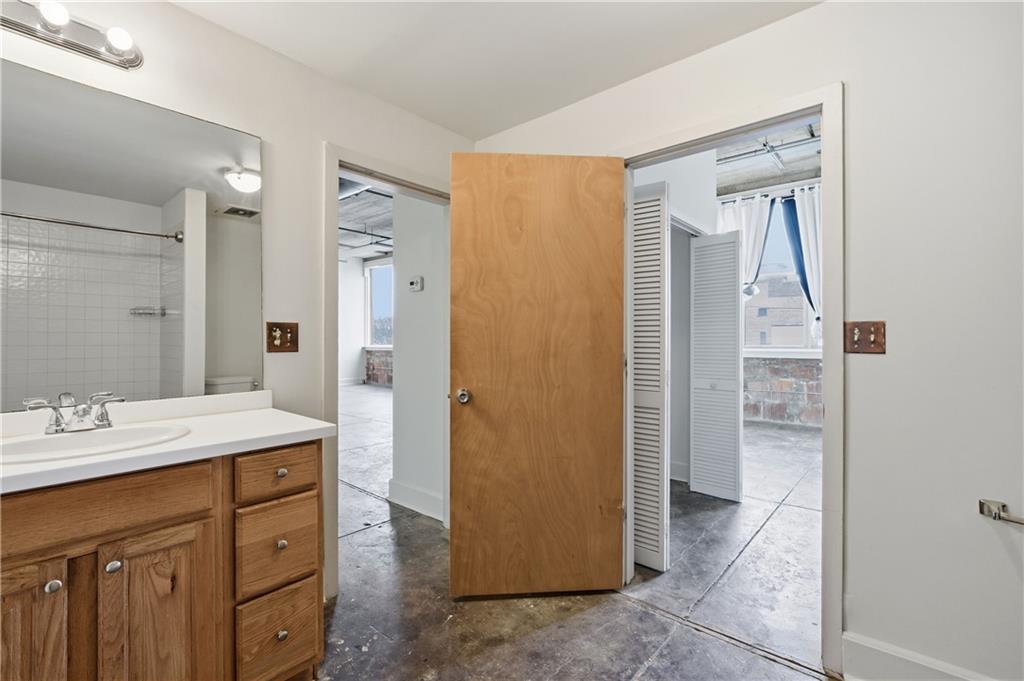 505 Whitehall Street Southwest, Unit 204 Atlanta, GA 30303 - Photo 13 of 33 a bathroom with a granite countertop sink mirror and a
