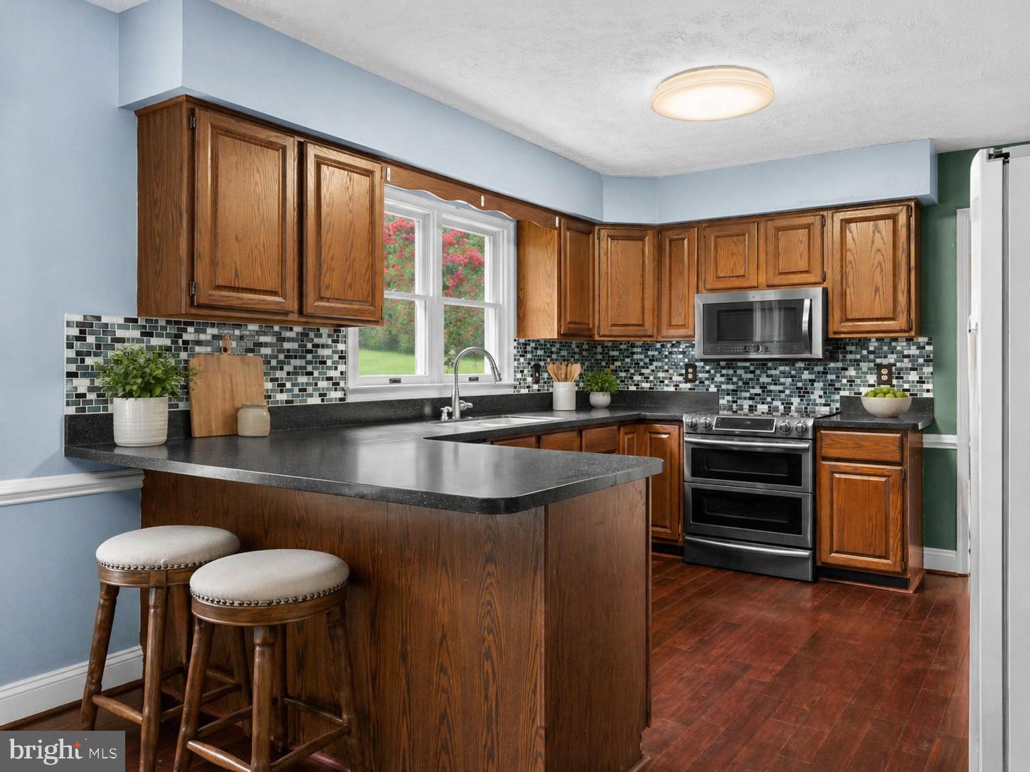 13360 Cameron Court Boston, VA 22713 - Photo 3 of 76 a kitchen with stainless steel appliances kitchen island granite countertop a stove a sink and a microwave