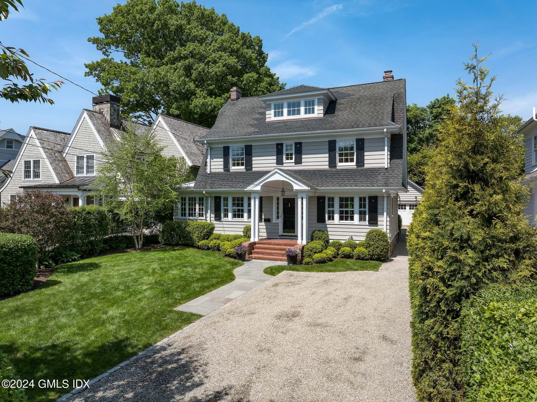 89 Shore Road Old Greenwich, CT 06870 - Photo 1 of 36 a front view of a house with a yard