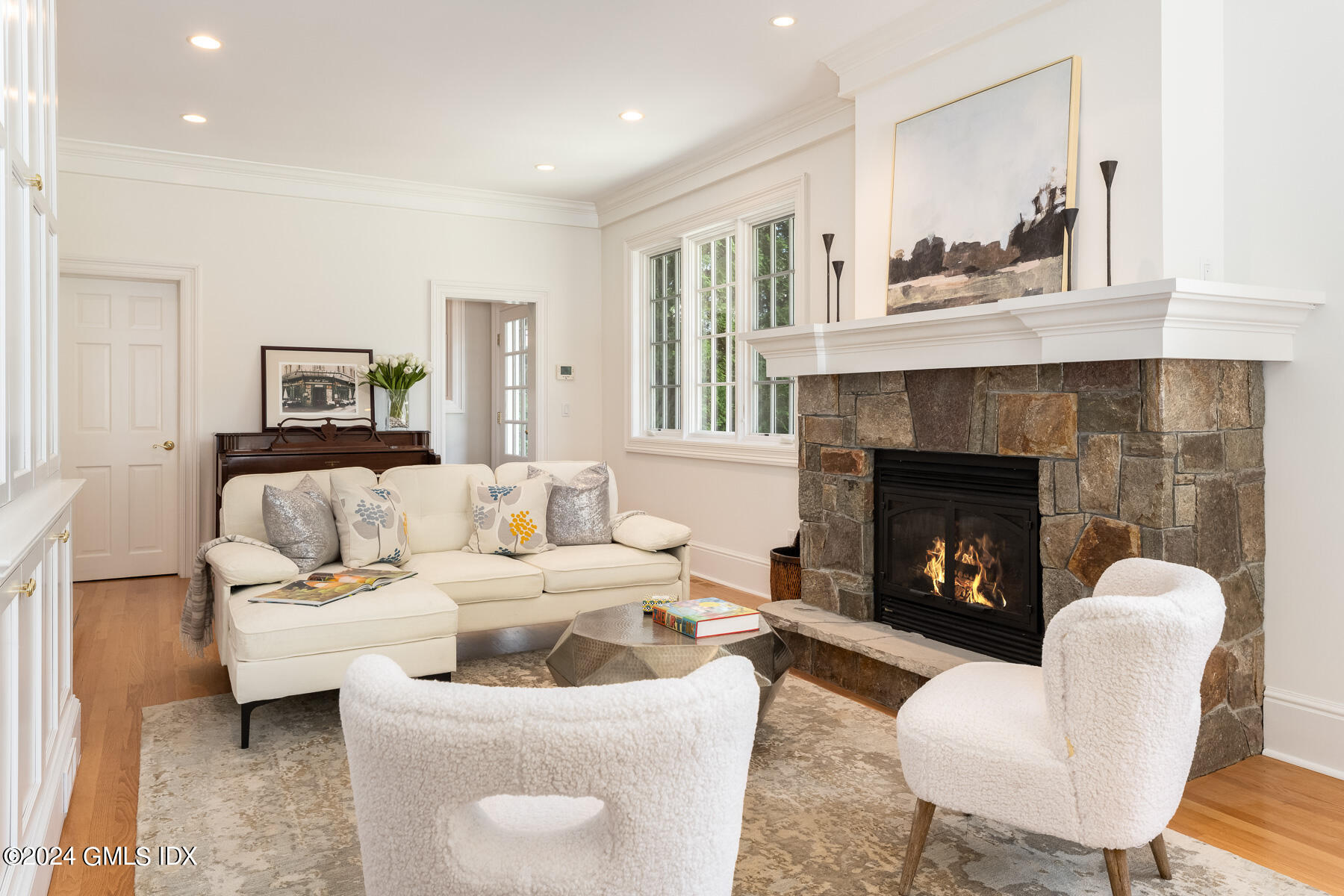 89 Shore Road Old Greenwich, CT 06870 - Photo 15 of 36 a living room with furniture and a fireplace