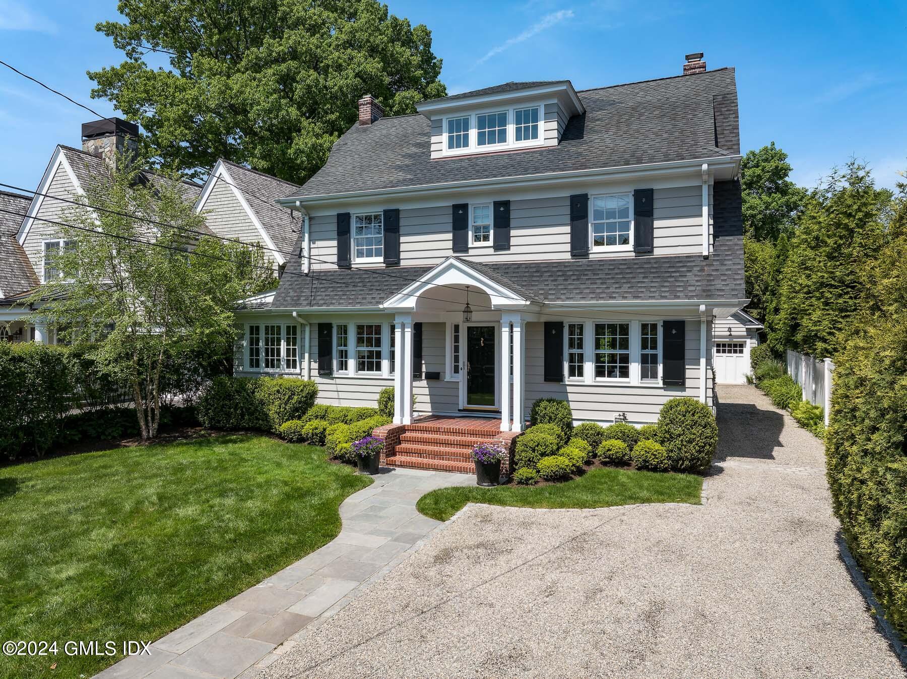 89 Shore Road Old Greenwich, CT 06870 - Photo 2 of 36 a front view of a house with garden and porch