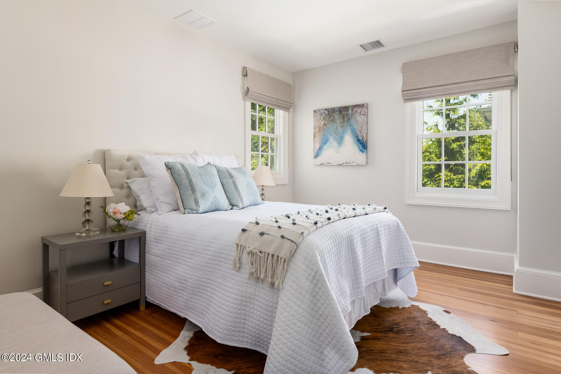 89 Shore Road Old Greenwich, CT 06870 - Photo 22 of 36 a bed sitting in a bedroom next to a window