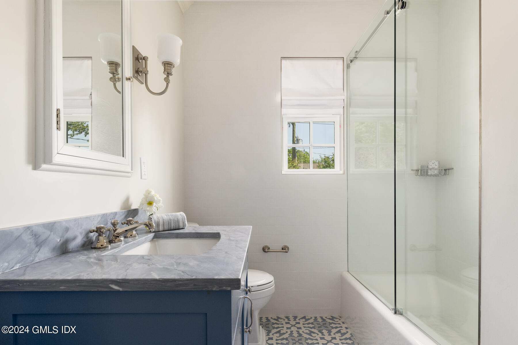 89 Shore Road Old Greenwich, CT 06870 - Photo 23 of 36 a bathroom with a granite countertop sink a toilet and shower