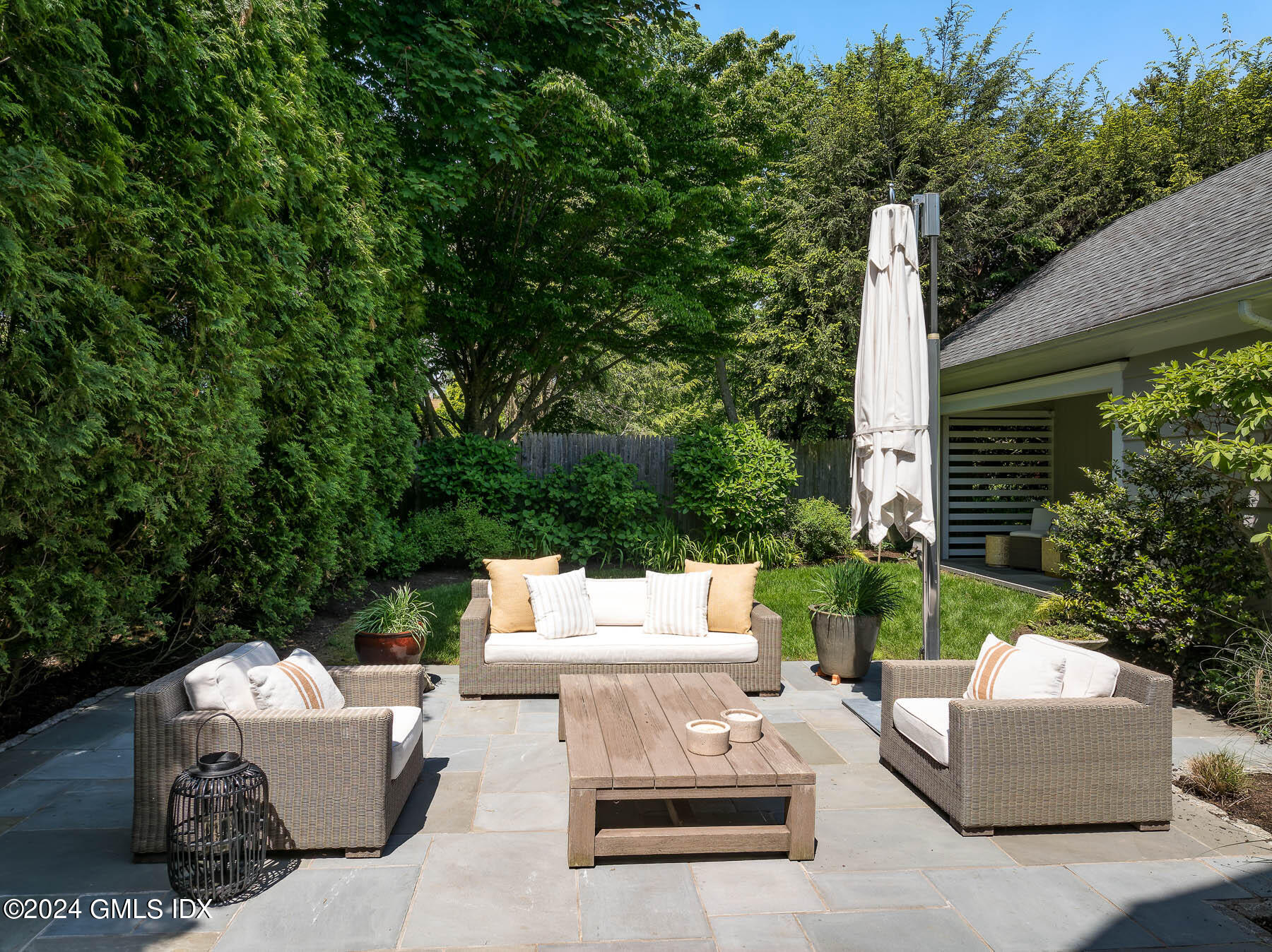89 Shore Road Old Greenwich, CT 06870 - Photo 27 of 36 a view of backyard with couches and potted plants