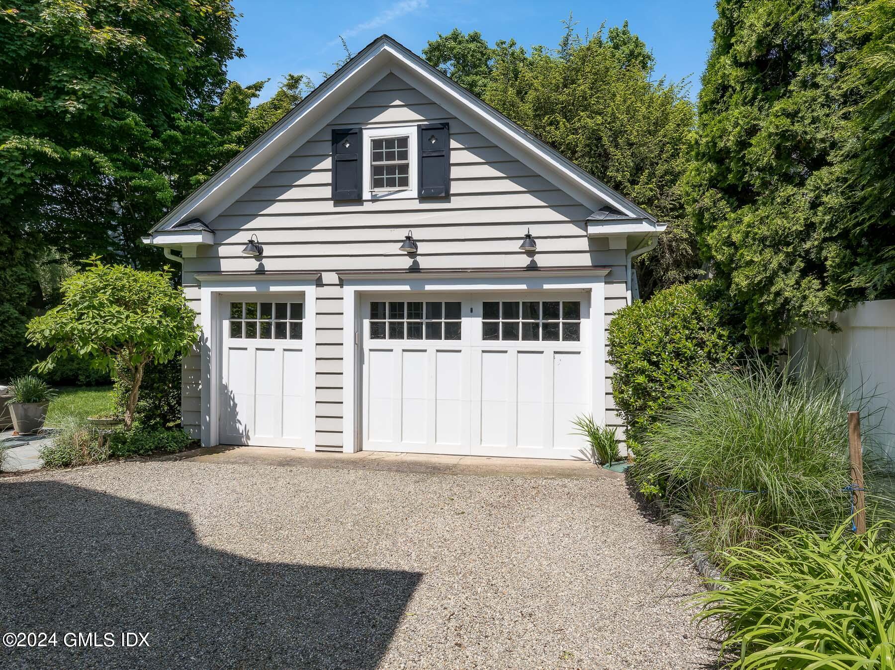 89 Shore Road Old Greenwich, CT 06870 - Photo 30 of 36 a front view of a house with a garden