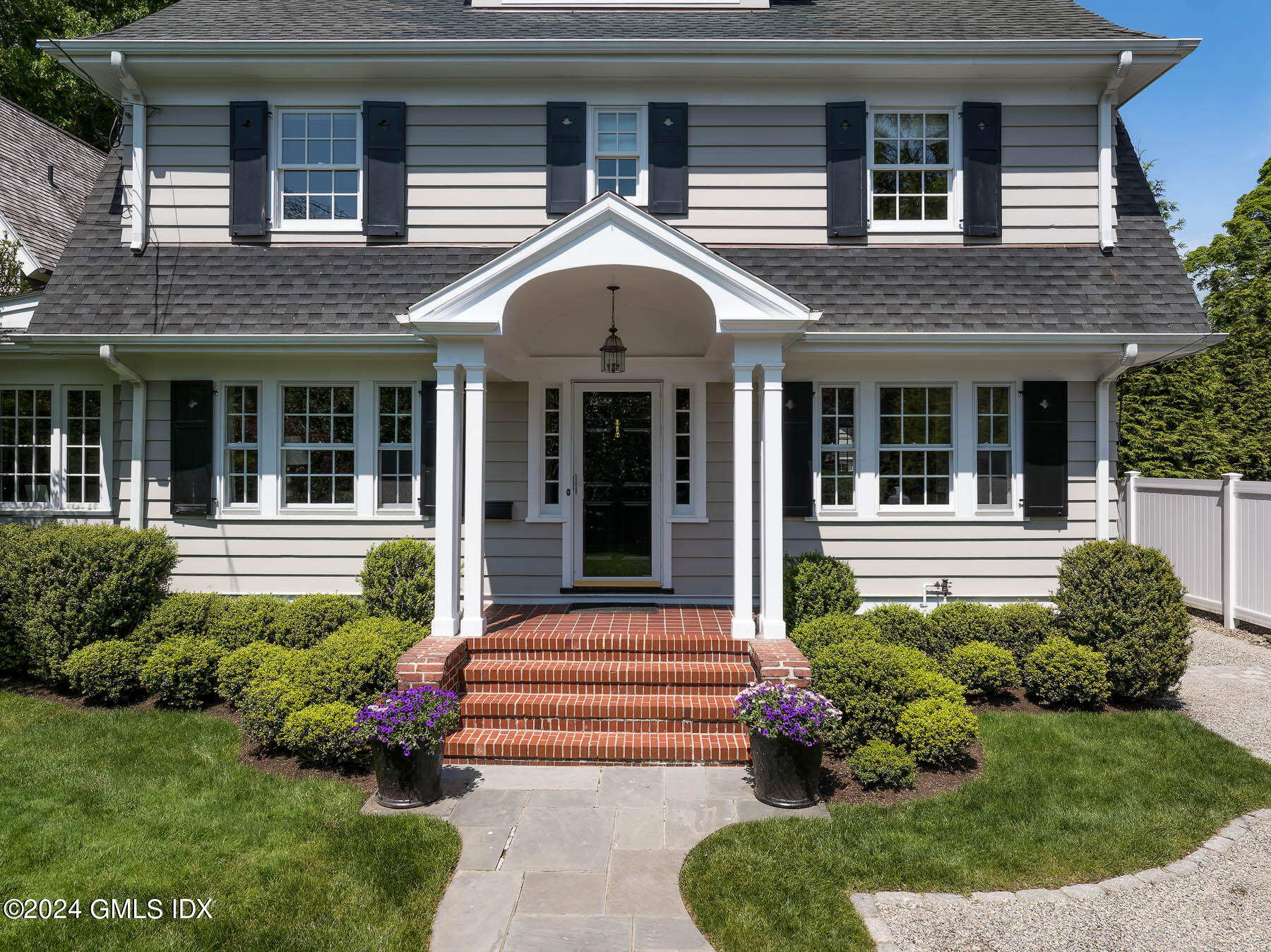 89 Shore Road Old Greenwich, CT 06870 - Photo 5 of 36 a front view of a house with garden