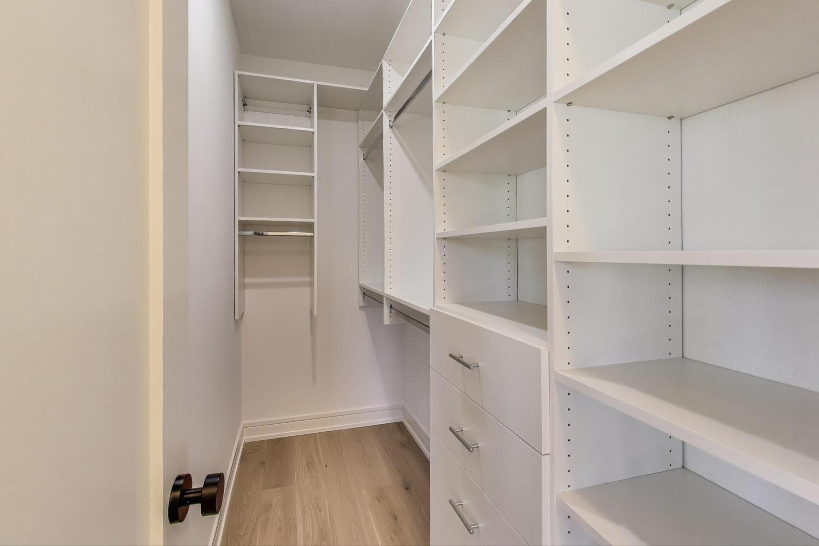 2213 West Huron Street Chicago, IL 60612 - Photo 25 of 42 a view of walk in closet with empty racks
