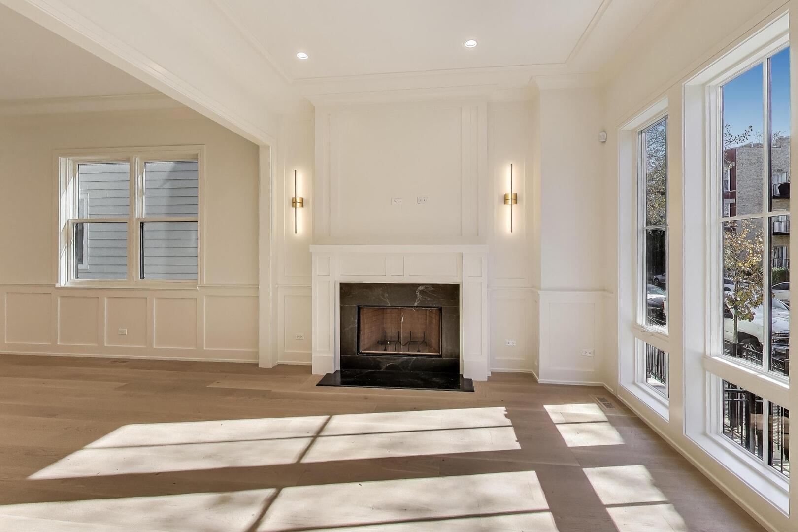 2213 West Huron Street Chicago, IL 60612 - Photo 3 of 42 a living room with a fireplace cabinets and a rug