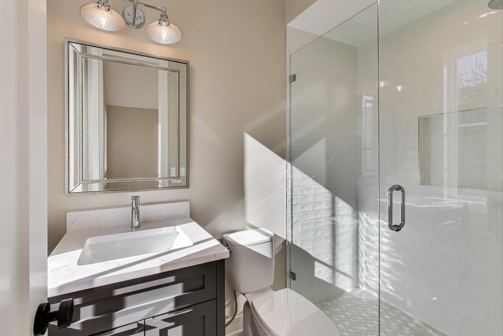 2213 West Huron Street Chicago, IL 60612 - Photo 33 of 42 a bathroom with a sink a toilet and a mirror