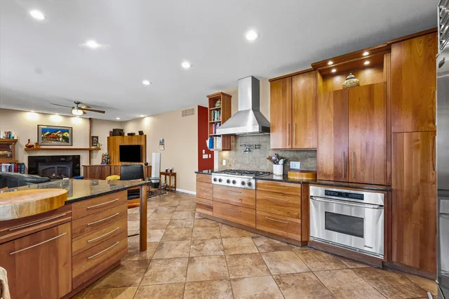 a bathroom with a granite countertop sink and washing machine