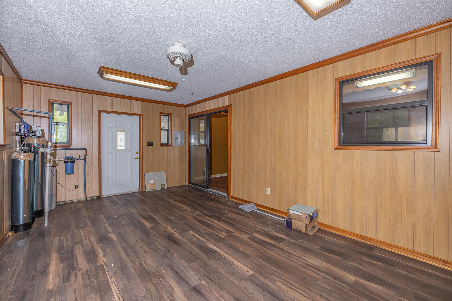 3877 Hinote Road Crestview, FL 32539 - Photo 19 of 33 a view of a livingroom with wooden floor and a ceiling fan