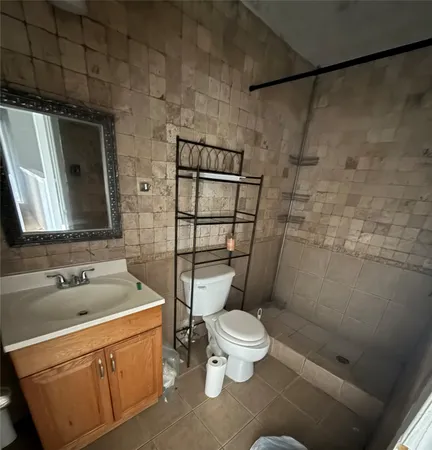 a bathroom with a sink toilet and shower