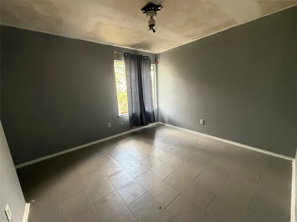 an empty room with windows and closet