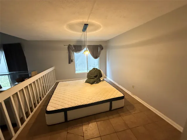 a bed room with a bed and a chandelier