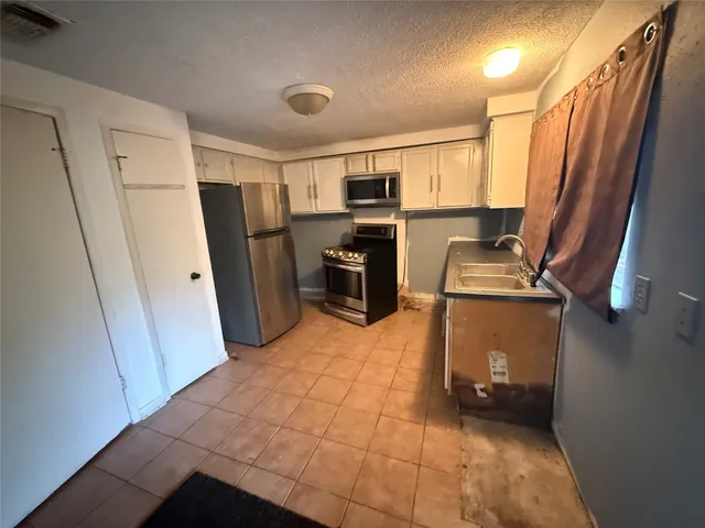 a room with refrigerator and washer