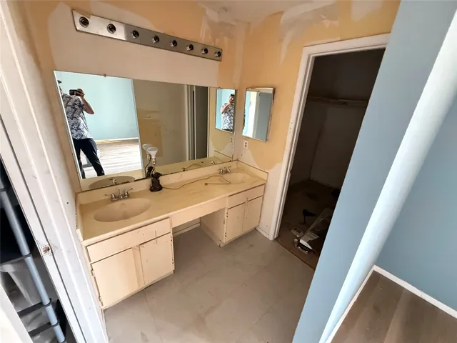 a bathroom with a sink a mirror and a shower