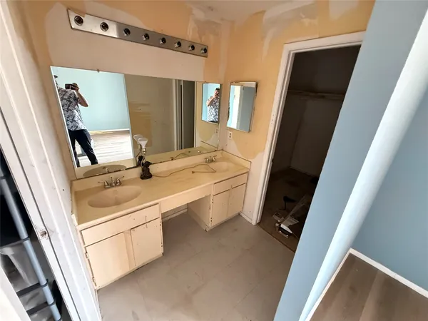 a bathroom with a sink a mirror and a shower
