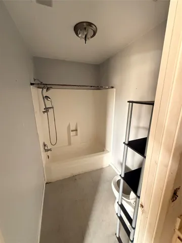 a bathroom with a bathtub and shower