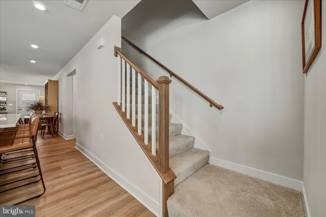 a view of entryway and hall with wooden floor