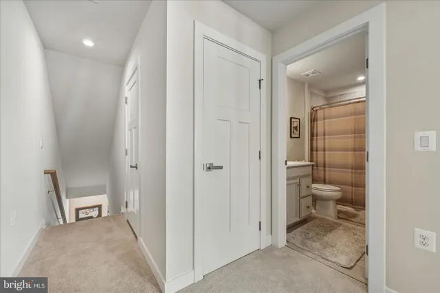 a bathroom with a granite countertop toilet sink and shower