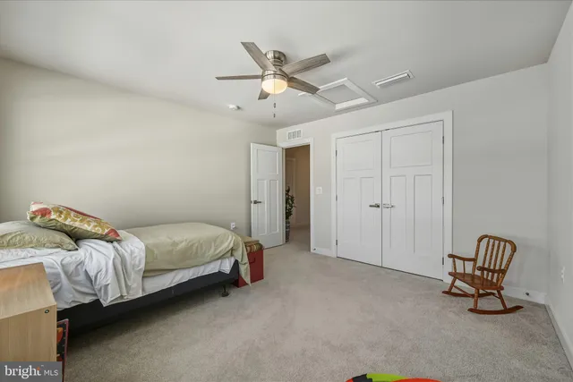 a bed room with a bed and a ceiling fan