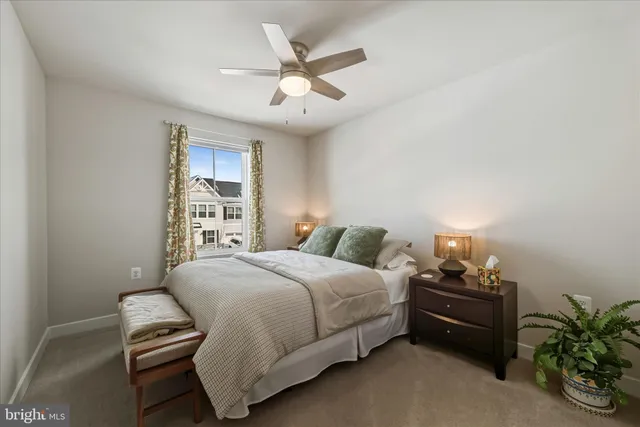 a bedroom with a bed and a ceiling fan