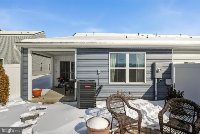 a view of a patio with table and chairs with wooden floor and fence