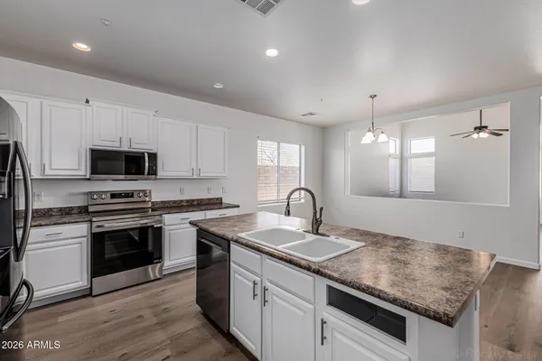 a kitchen with sink stove and microwave
