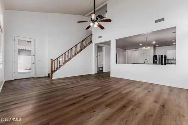 a view of a room with wooden floor and white walls