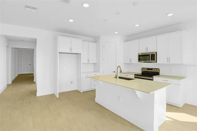 a view of a kitchen with electric appliances