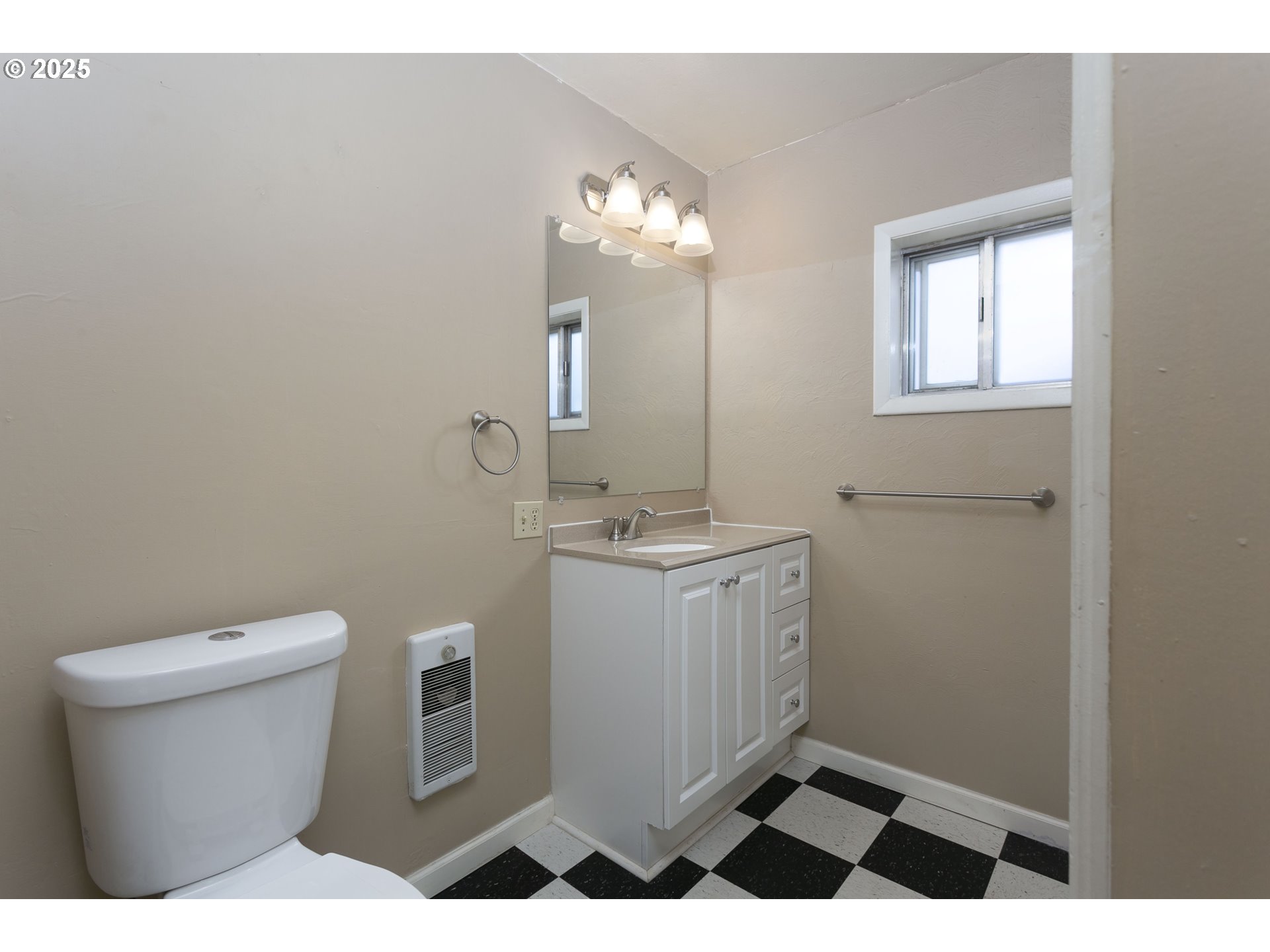 9628 Southeast Holgate Boulevard Portland, OR 97266 - Photo 14 of 15 a bathroom with a toilet a sink and mirror