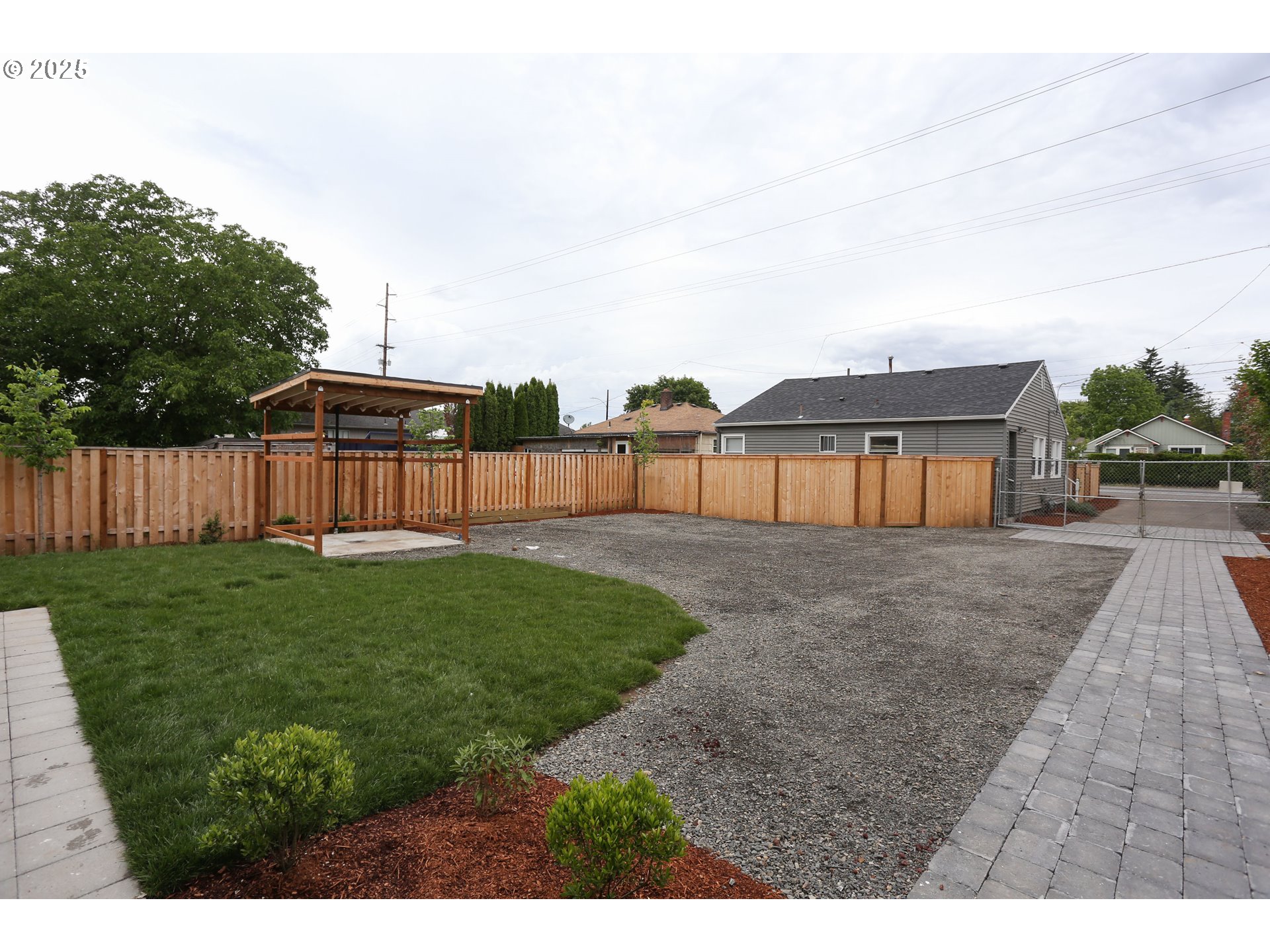 9628 Southeast Holgate Boulevard Portland, OR 97266 - Photo 7 of 15 a view of a backyard with grass and a garden