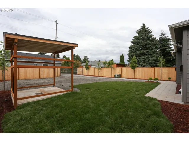 a view of a backyard with a table and chairs