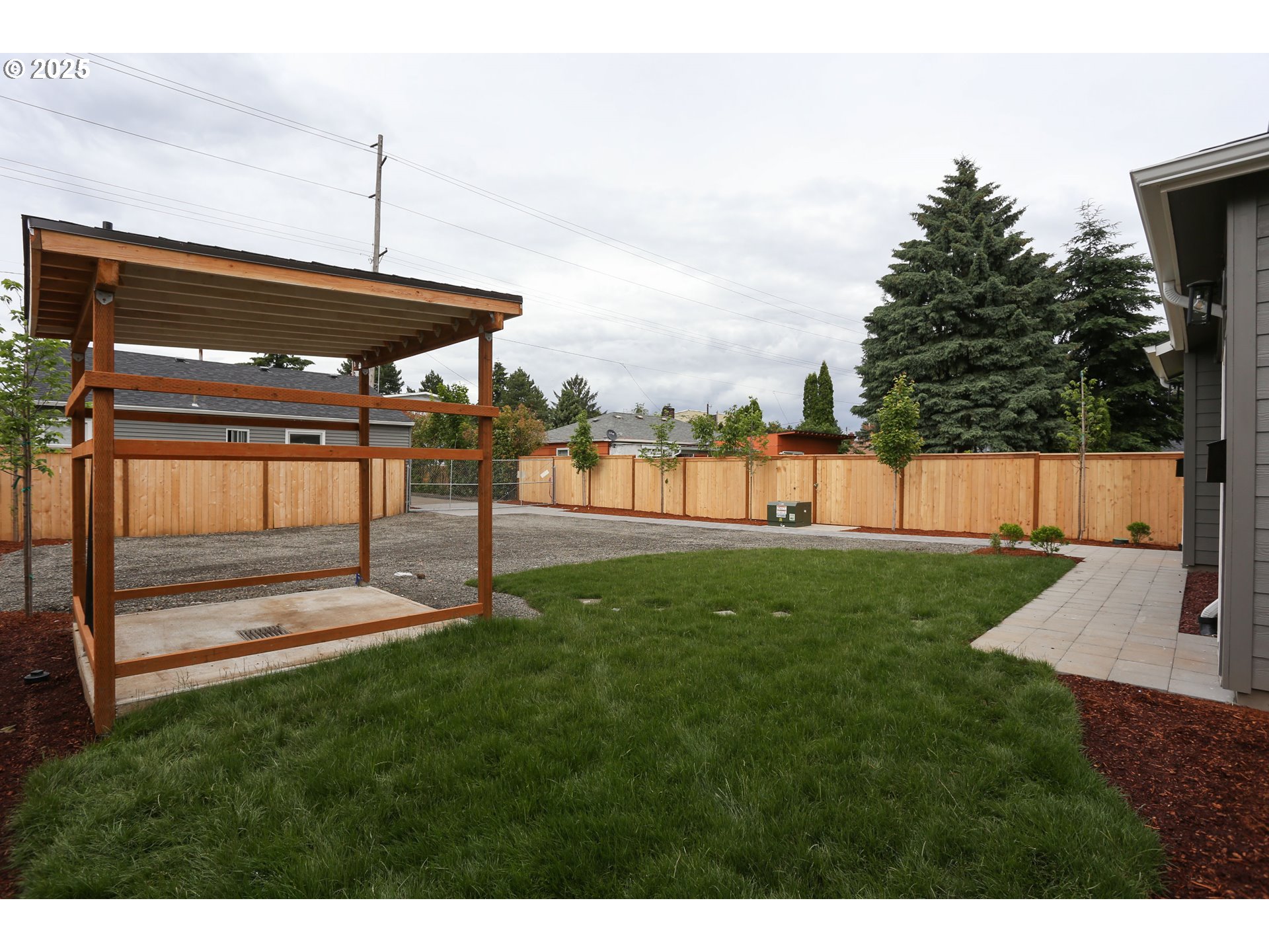 9628 Southeast Holgate Boulevard Portland, OR 97266 - Photo 8 of 15 a view of a backyard with a table and chairs