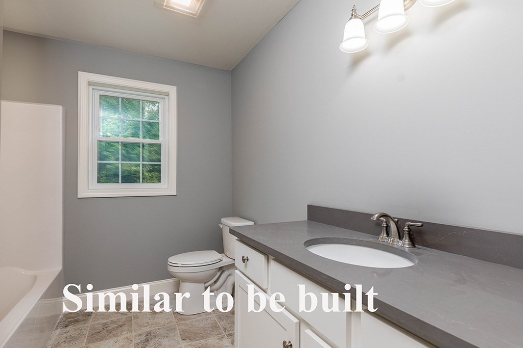 677 South Road Templeton, MA 01468 - Photo 22 of 23 a bathroom with a toilet a sink a mirror and a window