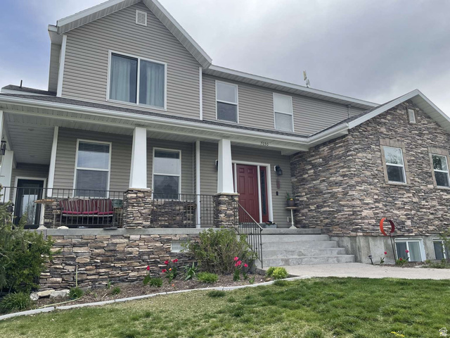 7030 West 2100 North Mendon, UT 84325 - Photo 3 of 67 Two-story residence featuring a combination of horizontal siding and stacked stone veneer