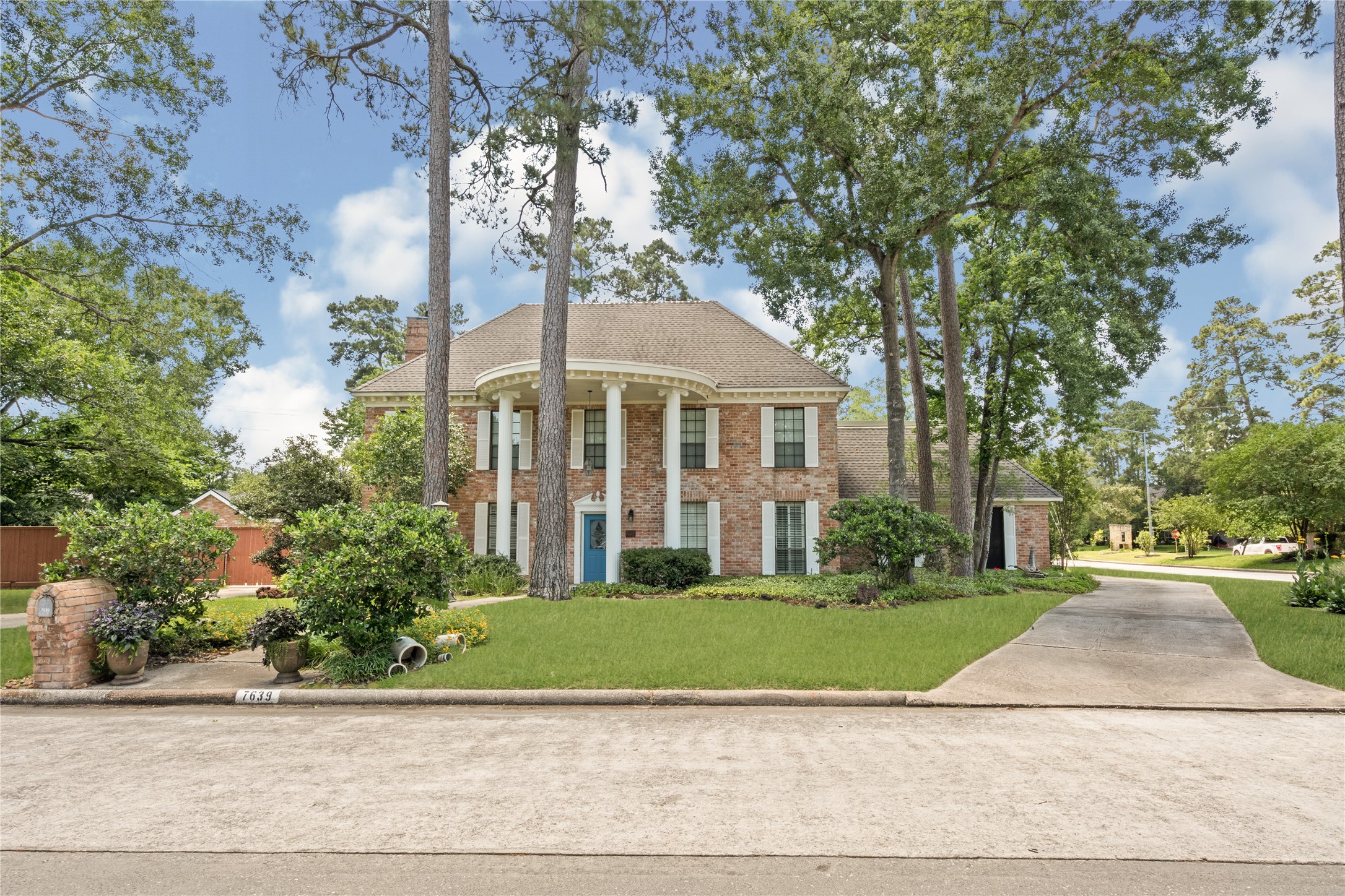7639 Post Bridge Road Spring, TX 77389 - Photo 3 of 42 a front view of a house with a yard and potted plants