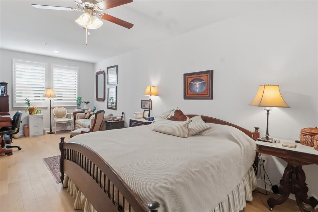 651 Watters Road, Unit 8202 Allen, TX 75013 - Photo 11 of 32 a bedroom with a bed and a chandelier