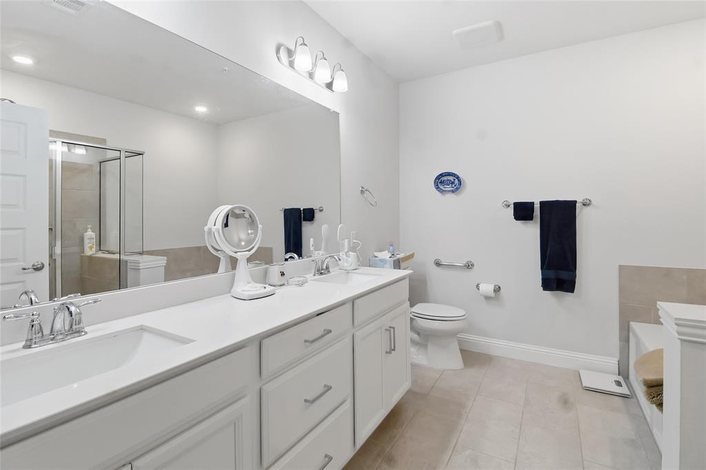 651 Watters Road, Unit 8202 Allen, TX 75013 - Photo 12 of 32 a bathroom with a toilet sink double vanity and mirror