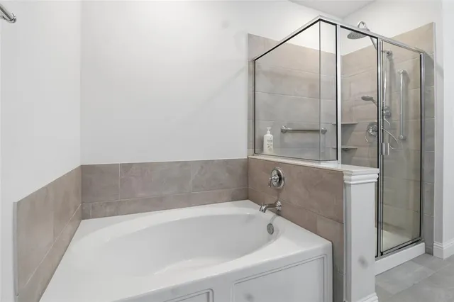 a bathroom with a toilet sink double vanity and mirror