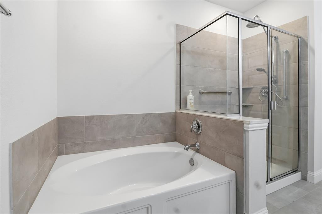 651 Watters Road, Unit 8202 Allen, TX 75013 - Photo 13 of 32 a bathroom with a bathtub and a shower